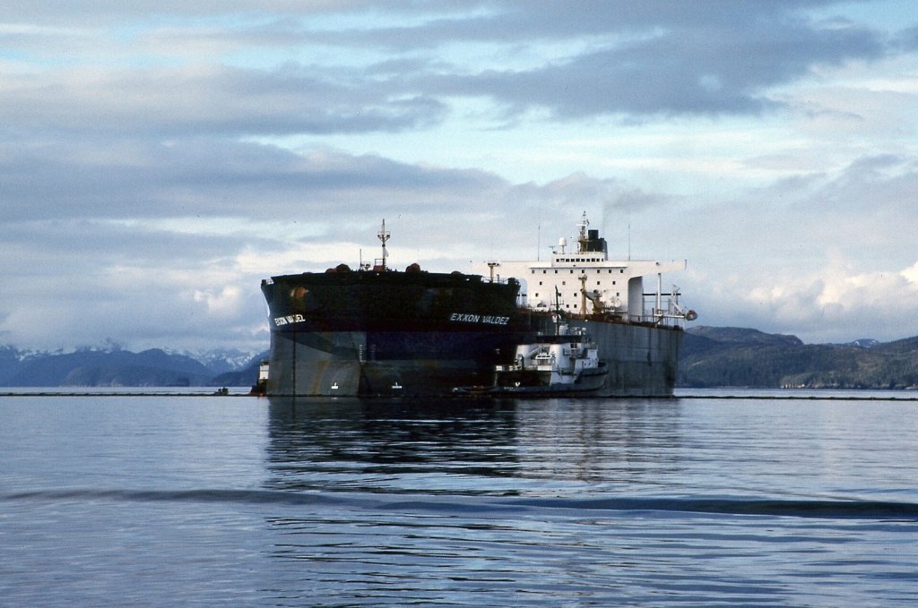 Exxon Valdez in Prince William Sound after the grounding in 1989, with a smaller vessel alongside