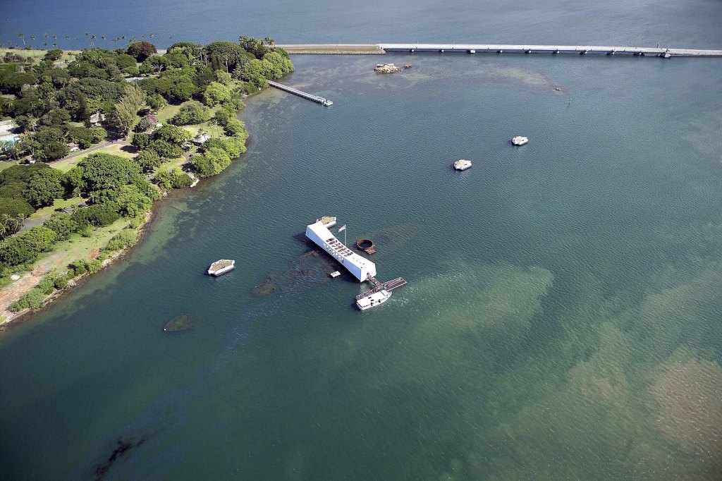 The USS Arizona Memorial spanning the sunken hull of the battleship at Pearl Harbor